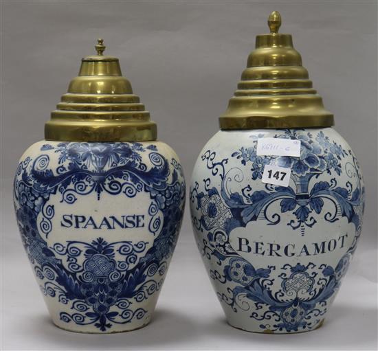 Two Dutch delft drug jars Spanse and Bergomot, with brass covers height 37cm